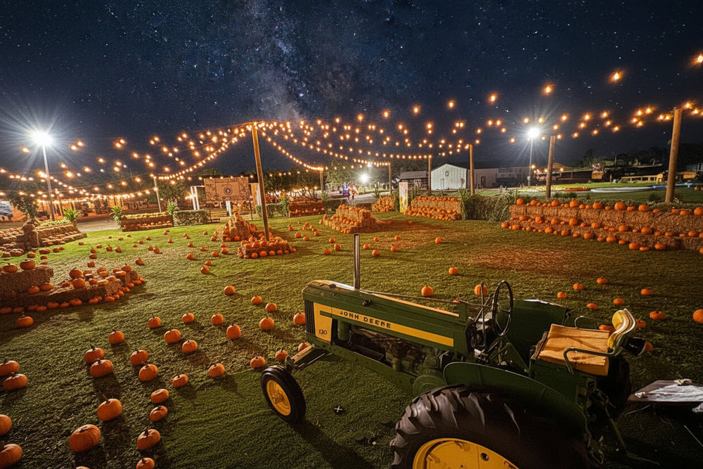 Tractor in a pumpkin patch at night with string lights and hay bales at The Berry Farm during Harvest Festival extended hours.